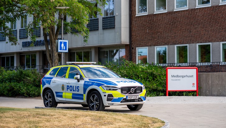 En polisbil parkerad framför en byggnad